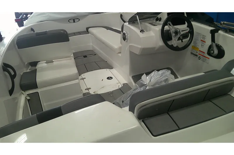 Slide: The Image of Interior of a 2026 Tahoe T16 boat featuring seating and steering console. - 7