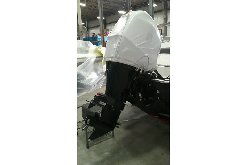 Slide: The Image of 2026 Tahoe T16 boat engine covered in protective wrap in a warehouse setting. - 4