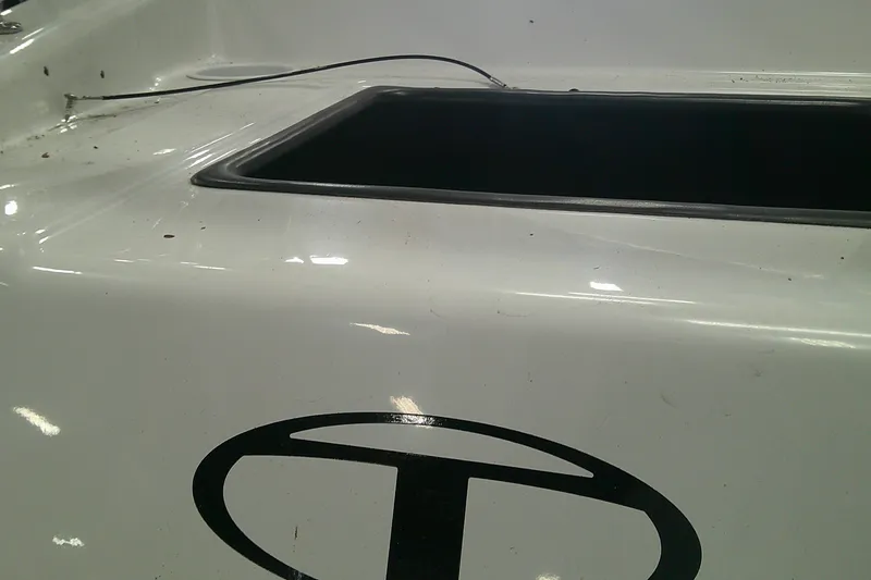 Slide: The Image of 2026 Tahoe T16 boat detail with logo and open compartment. - 2