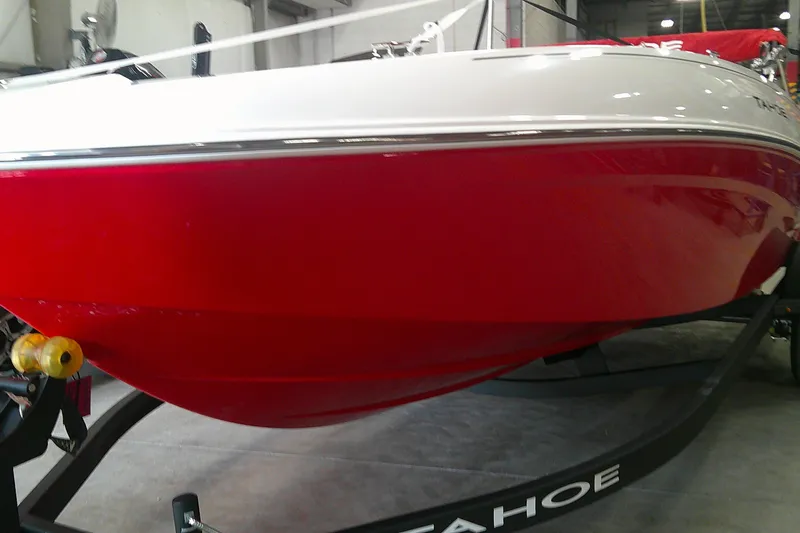 Slide: The Image of 2026 Tahoe T18 boat with a sleek red and white hull on display. - 3
