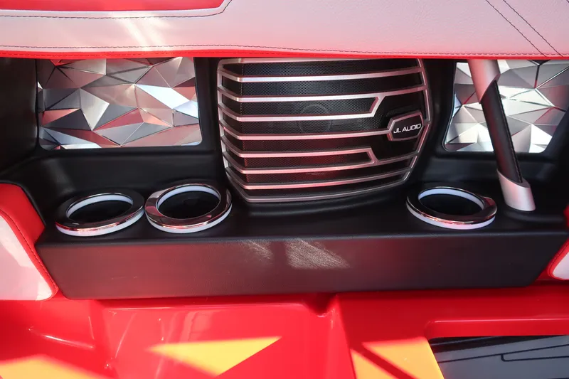 Slide: The Image of 2019 Nautique Super Air Nautique G23 interior with JL Audio speaker and cup holders. - 16
