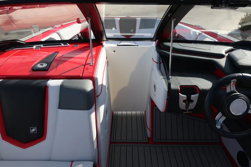 Slide: The Image of 2019 Nautique Super Air Nautique G23 interior with red and gray seating and dashboard. - 6