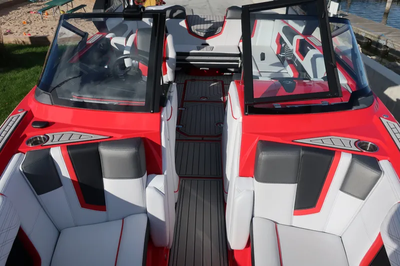 Slide: The Image of 2019 Nautique Super Air Nautique G23 interior with red and white seating, open windshield. - 4
