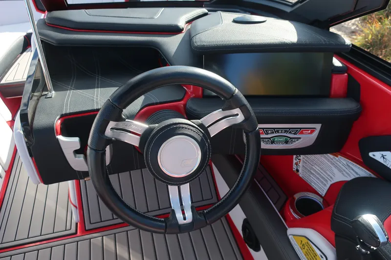 Slide: The Image of 2019 Nautique Super Air Nautique G23 dashboard with steering wheel and control panel. - 7