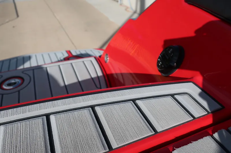 Slide: The Image of 2019 Nautique Super Air Nautique G23 boat deck with red and gray detailing. - 14