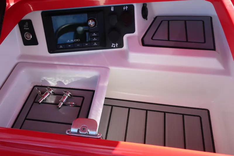 Slide: The Image of 2019 Nautique Super Air Nautique G23 dashboard with JL Audio system and controls. - 26