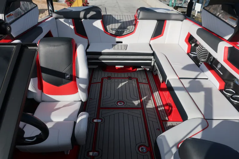 Slide: The Image of 2019 Nautique Super Air Nautique G23 interior with red and gray seating and flooring. - 17