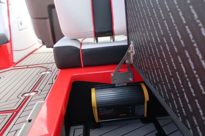 Slide: The Image of 2019 Nautique Super Air Nautique G23 interior with red accents and ProSport charger. - 22