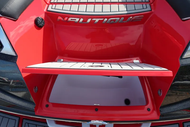 Slide: The Image of 2019 Nautique Super Air Nautique G23 boat storage compartment, red exterior, open hatch. - 8