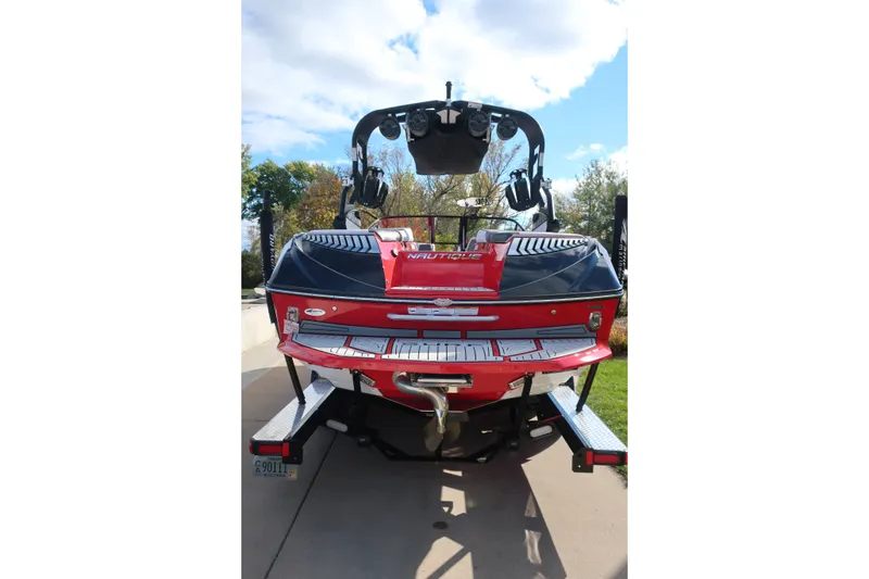 Slide: The Image of 2019 Nautique Super Air Nautique G23 boat, rear view, on trailer, sunny day. - 1