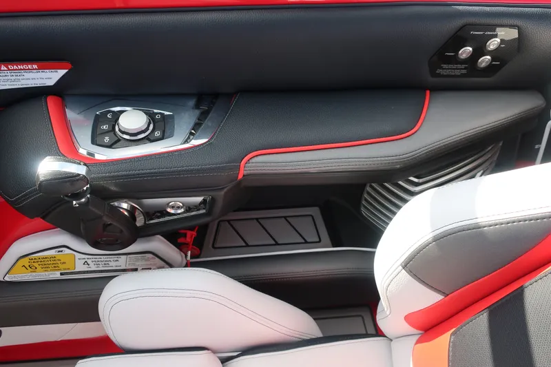 Slide: The Image of 2019 Nautique Super Air Nautique G23 interior with red and black accents, control panel, and seating. - 23