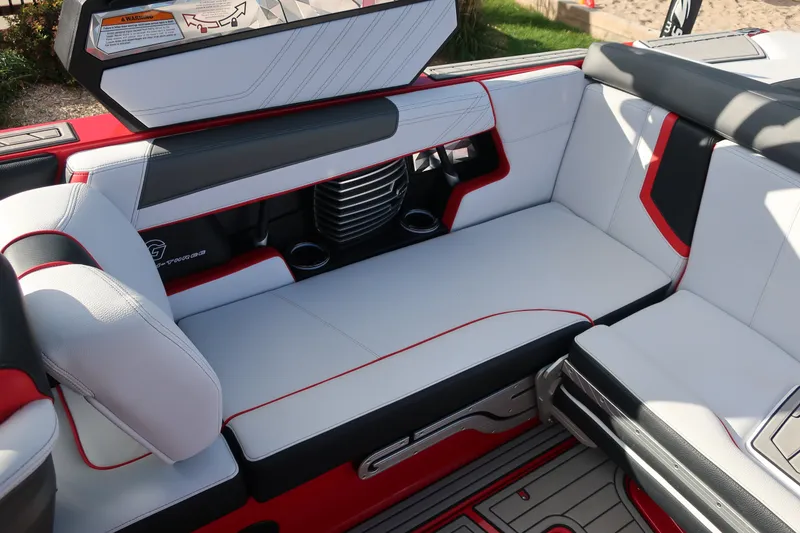 Slide: The Image of 2019 Nautique Super Air Nautique G23 interior with red and white seating, cup holders, and sleek design. - 18