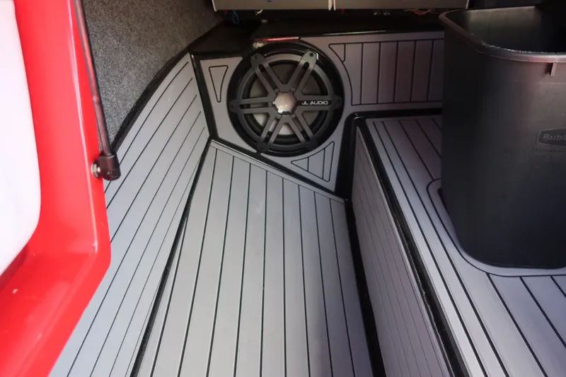 Slide: The Image of 2019 Nautique Super Air Nautique G23 interior with JL Audio speaker and storage area. - 15