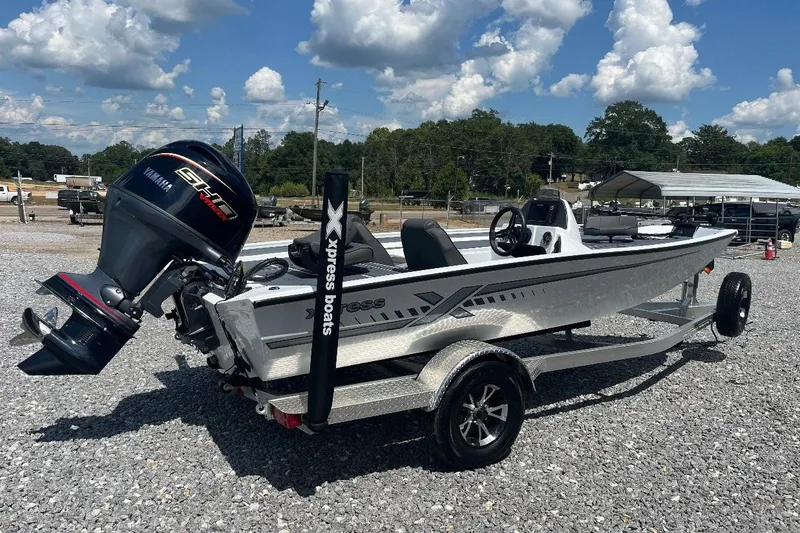 Slide: The Image of 2027 Xpress H18 Bass boat with Yamaha engine on gravel lot under blue sky. - 16