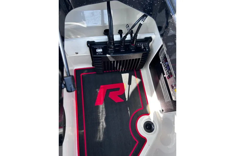 Slide: The Image of 2024 Ranger Z520R boat interior with electronic controls and branded floor mat. - 17
