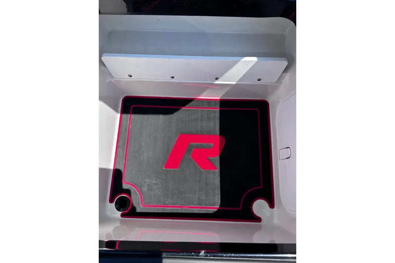 Slide: The Image of 2024 Ranger Z520R boat compartment with custom mat featuring red "R" logo. - 31