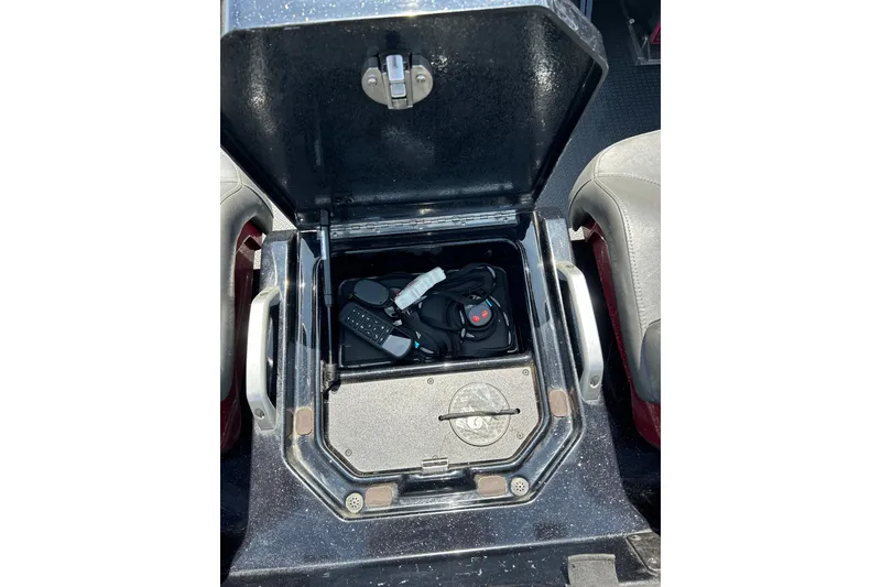 Slide: The Image of Open storage compartment in 2024 Ranger Z520R boat with accessories inside. - 23