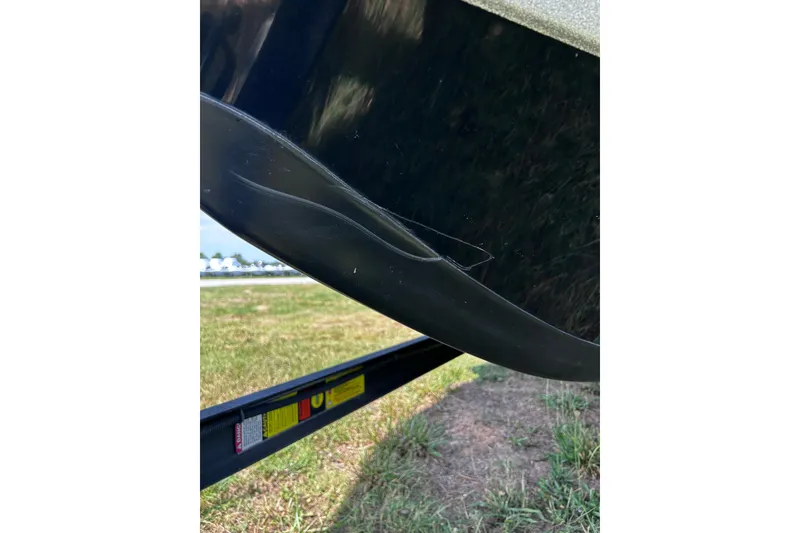 Slide: The Image of Close-up of 2024 Ranger Z520R boat hull with visible damage. - 41