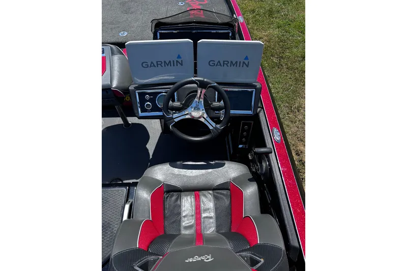 Slide: The Image of 2024 Ranger Z520R boat cockpit with Garmin displays and steering wheel, featuring red and black seating. - 25
