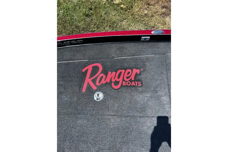 Slide: The Image of 2024 Ranger Z520R boat deck with logo, featuring textured surface and red trim. - 15