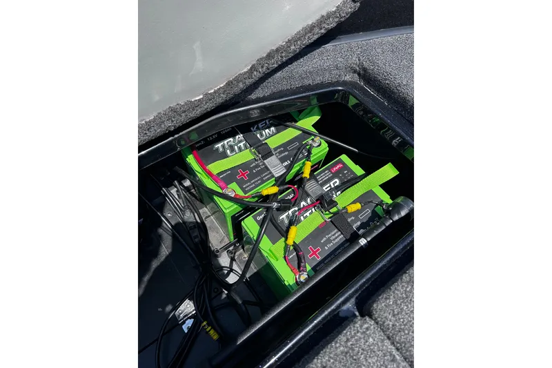 Slide: The Image of 2024 Ranger Z520R boat battery compartment with Tracker lithium batteries and wiring. - 32