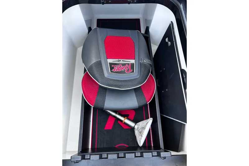 Slide: The Image of 2024 Ranger Z520R boat storage with red and black seat and anchor. - 18