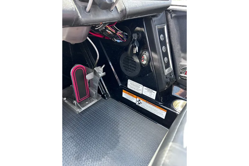 Slide: The Image of 2024 Ranger Z520R boat interior showing control panel and foot pedal. - 26