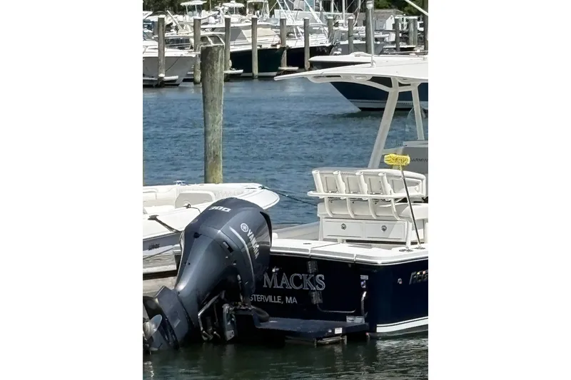 Slide: The Image of 2014 Regulator 23 Forward Seating boat docked with Yamaha outboard motor. - 5