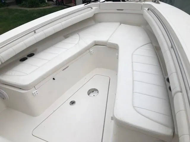 Slide: The Image of The image shows the forward seating area of a Regulator 23 boat with white upholstery. - 8