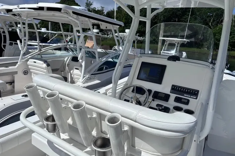 Slide: The Image of 2014 Regulator 23 Forward Seating boat with modern helm and rod holders. - 6