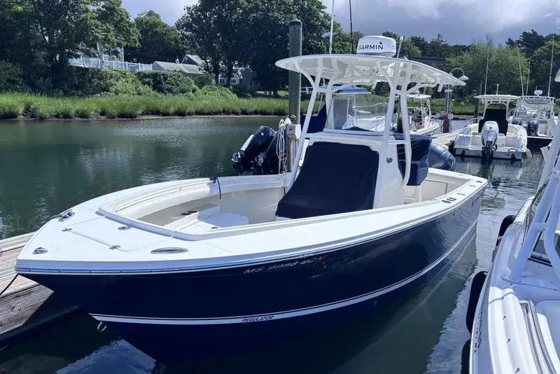 The Image of 2014 Regulator 23 Forward Seating boat docked in a serene marina setting. - 0