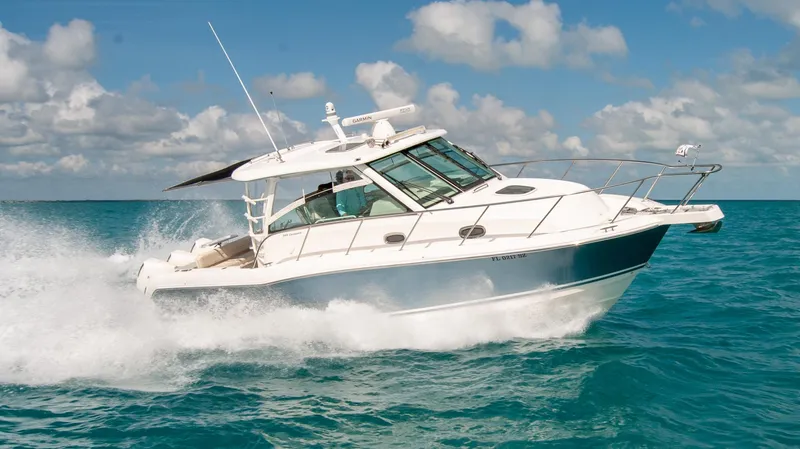 Slide: The Image of 2021 Boston Whaler 345 Conquest cruising on clear blue ocean waters. - 2