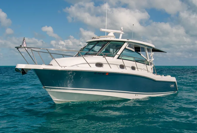 Slide: The Image of 2021 Boston Whaler 345 Conquest boat on open water under a cloudy sky. - 3