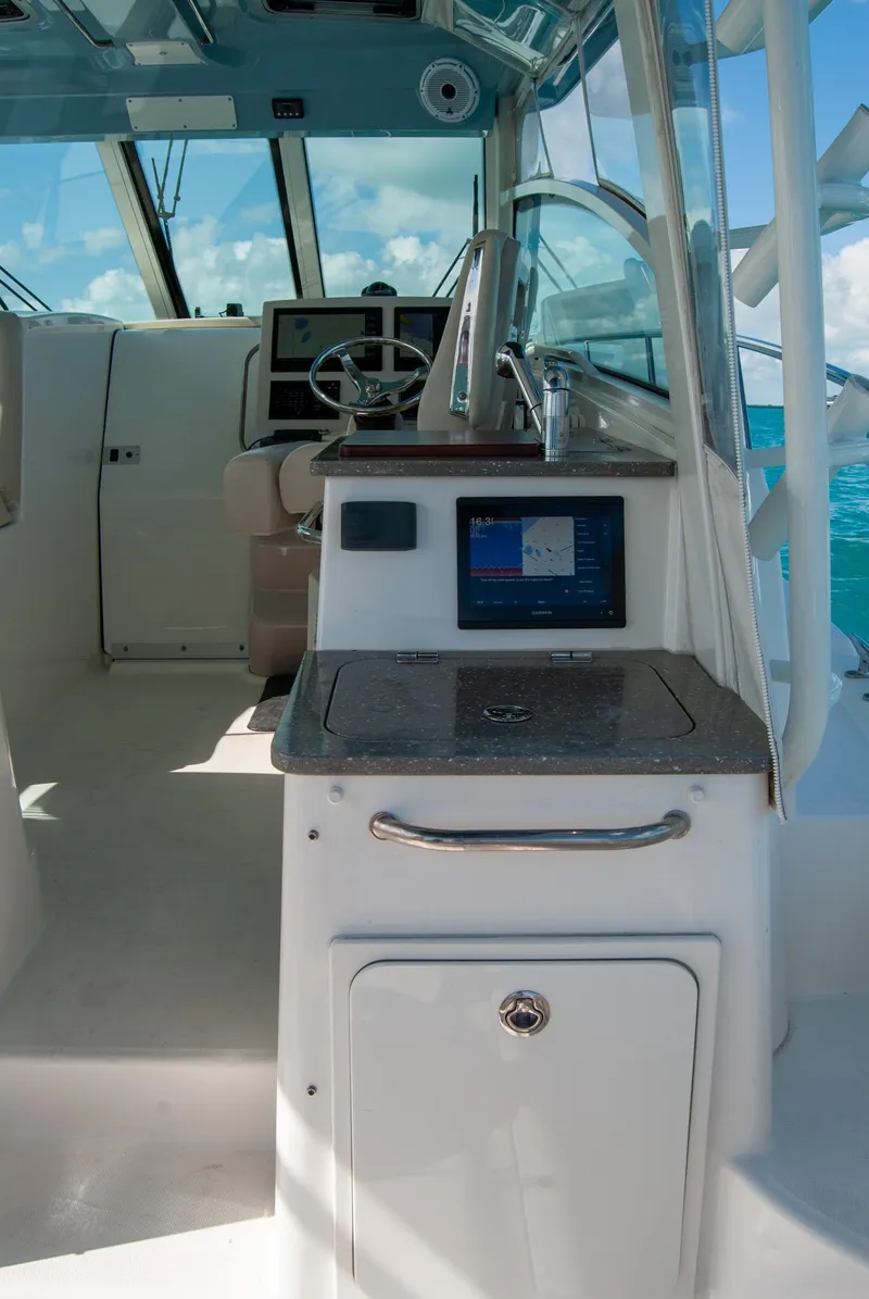 Slide: The Image of 2021 Boston Whaler 345 Conquest interior with helm and navigation equipment. - 49