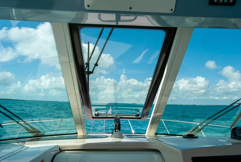 Slide: The Image of 2021 Boston Whaler 345 Conquest boat view, open sea, clear sky, through windshield. - 45