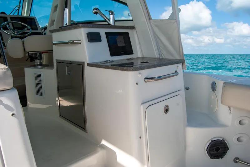Slide: The Image of 2021 Boston Whaler 345 Conquest interior with kitchenette, ocean view, and modern amenities. - 38