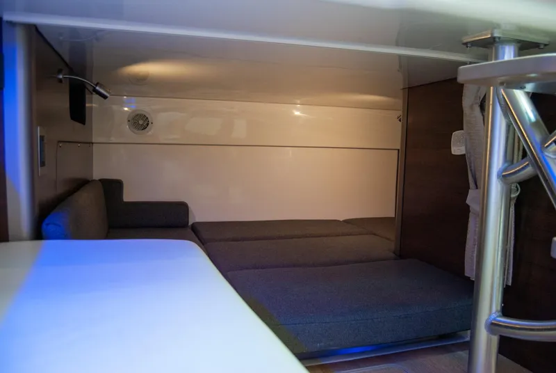 Slide: The Image of 2021 Boston Whaler 345 Conquest cabin interior with seating and table. - 34