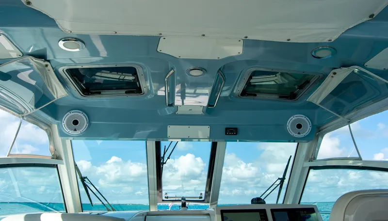 Slide: The Image of Interior view of 2021 Boston Whaler 345 Conquest boat with ocean backdrop. - 12