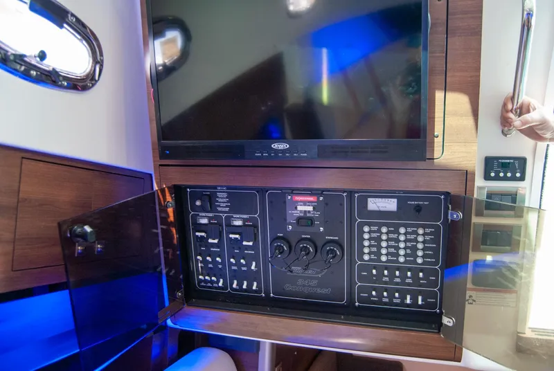 Slide: The Image of Control panel inside 2021 Boston Whaler 345 Conquest boat, featuring modern navigation and electronic systems. - 36