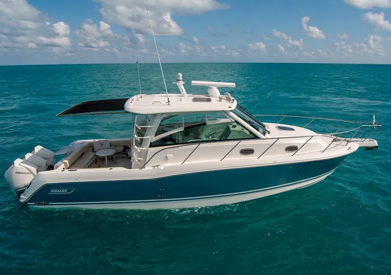 Slide: The Image of 2021 Boston Whaler 345 Conquest boat cruising on clear blue ocean waters. - 4