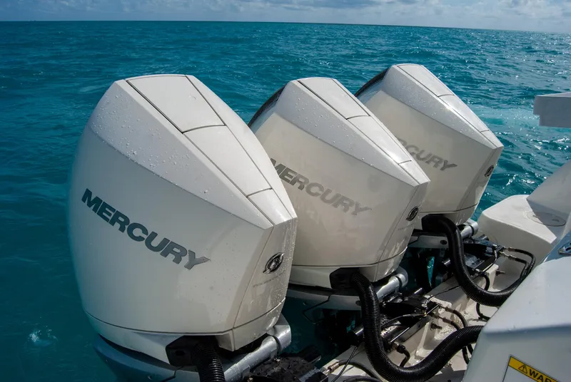 Slide: The Image of Triple Mercury outboard engines on a 2021 Boston Whaler 345 Conquest in blue ocean. - 7
