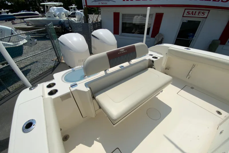 Slide: The Image of 2018 Cobia 301 Center Console boat interior with seating and twin engines. - 16