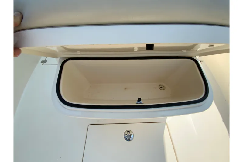 Slide: The Image of Open storage compartment on 2018 Cobia 301 Center Console boat. - 24