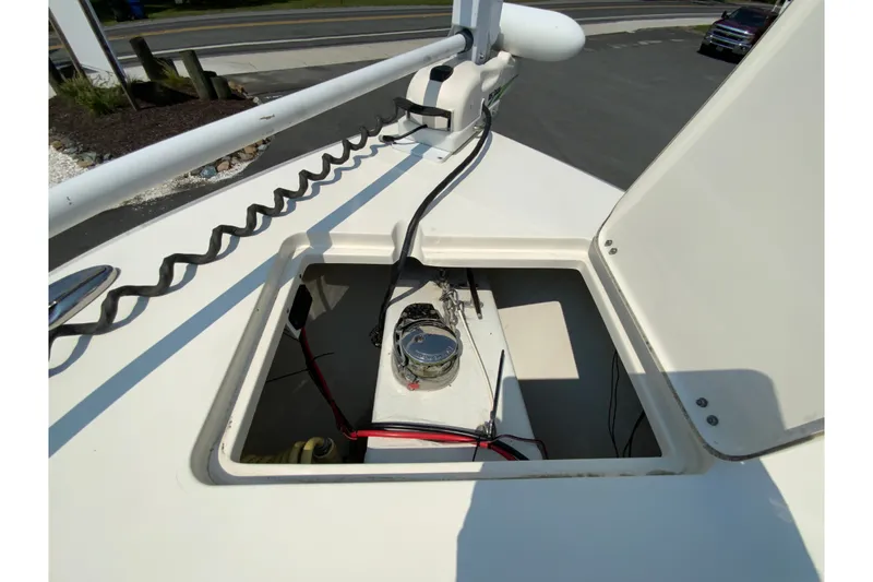 Slide: The Image of 2018 Cobia 301 Center Console boat storage compartment with wiring and equipment. - 22