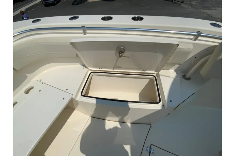 Slide: The Image of 2018 Cobia 301 Center Console boat with open storage compartment on deck. - 21