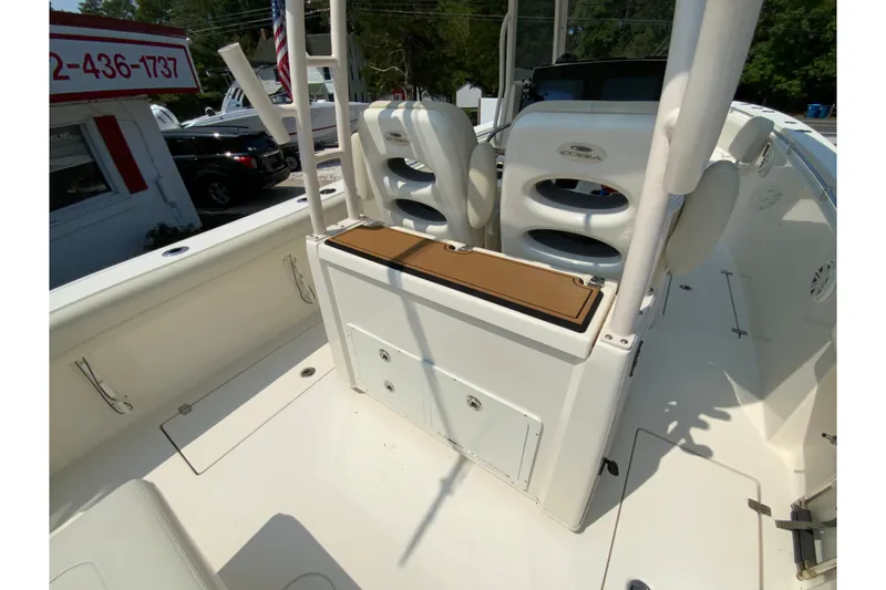 Slide: The Image of 2018 Cobia 301 Center Console boat interior with seating and storage compartments. - 17