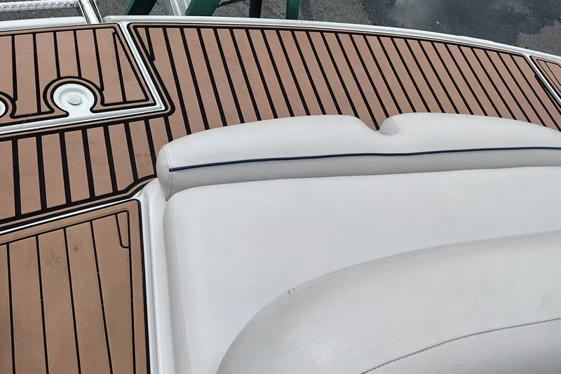 Slide: The Image of 2013 Crownline Eclipse E4 boat with teak-style deck and white cushioned seating. - 43