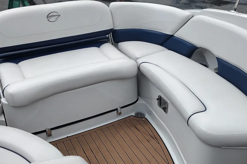 Slide: The Image of 2013 Crownline Eclipse E4 boat interior with white and blue seating, teak flooring. - 23