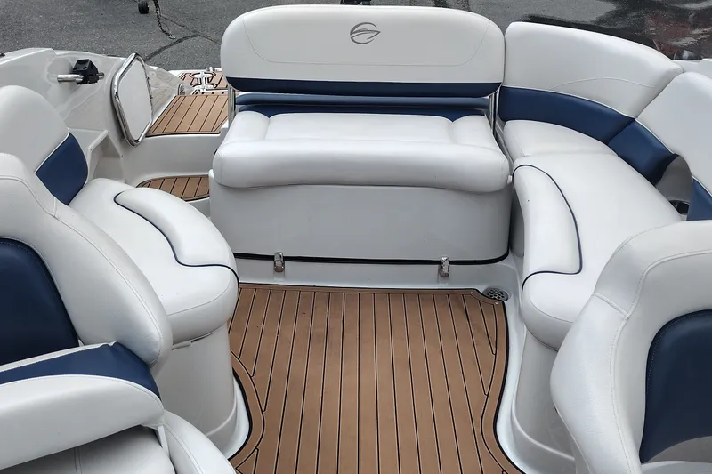 Slide: The Image of 2013 Crownline Eclipse E4 boat interior with white and blue seating, teak flooring. - 13