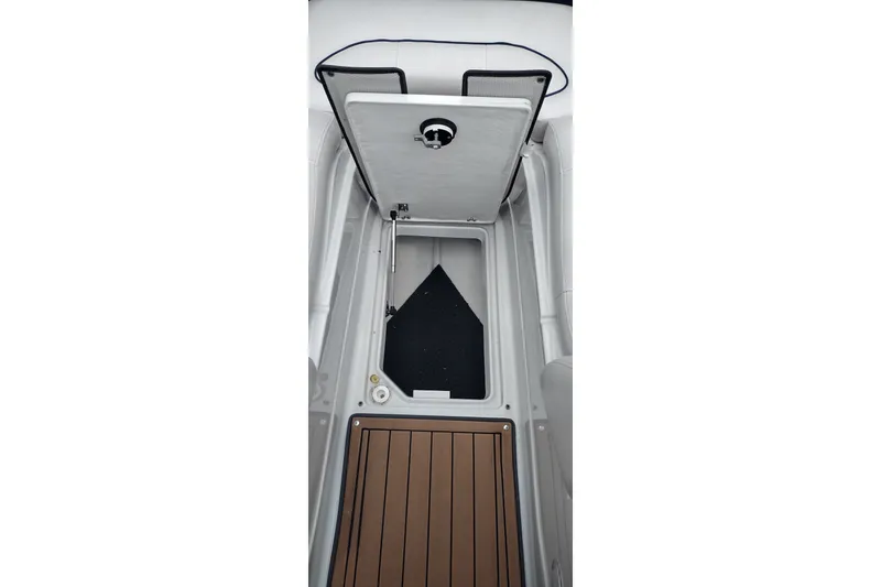 Slide: The Image of 2013 Crownline Eclipse E4 boat storage compartment with open hatch and wooden flooring. - 33